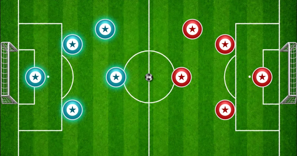 Finger Soccer futbol sahasında kırmızı ve mavi oyuncu diskleri